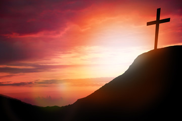 Silhouette cross on Calvary mountain sunset background. Easter concept