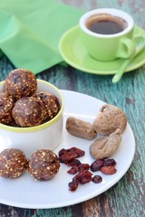Fig cranberry quinoa energy balls with cup of espresso. Vegan protein balls