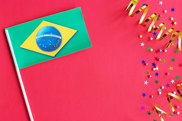 Brazil Independence Day. Brazil flag on a festive red background. The concept of celebration, patriotism and celebration. Copy space, flat lay