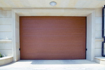 Shutter door or roller door and concrete floor outside .White Automatic shutters in a house . gates in the garage . Automatic Electric Roll-up Gate Or Push-up Door In The Modern Building  .