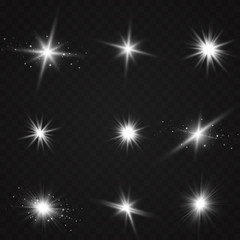 White glowing light explodes on a transparent background. Sparkling magical dust particles. Bright Star. Transparent shining sun, bright flash. Vector sparkles. To center a bright flash.