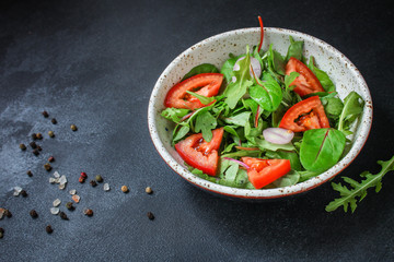 healthy salad tomato, mix leaves, onions and other ingredients, vegan, keto or paleo menu concept. top food background. copy space
