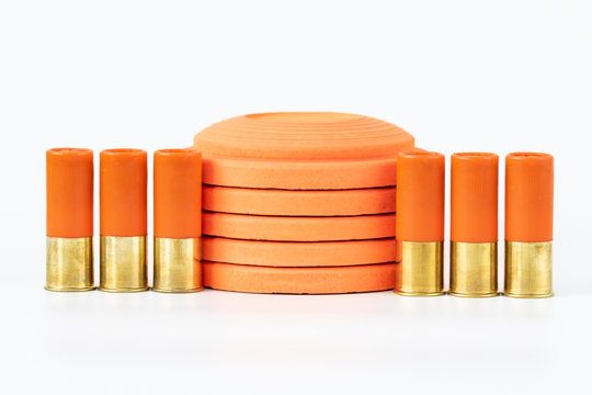Clay pigeons and shotgun cartridges on a white background