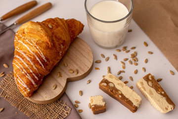 Appetizing Croissant, a glass of milk and slices of sweet sorbet. Tasty breakfast