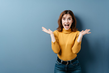 Young woman reacting in astonishment and surprise