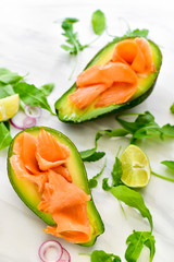 keto diet food : salmon and avocado  with arugula and lime. healthy lunch. ketogenic diet  food