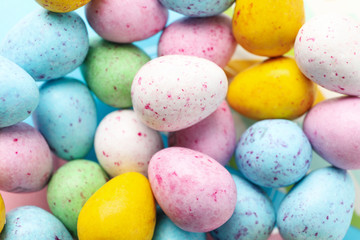 Multicolor small Easter eggs background, close up