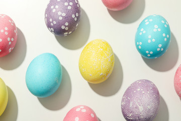 Flat lay. Multicolor Easter eggs on white background