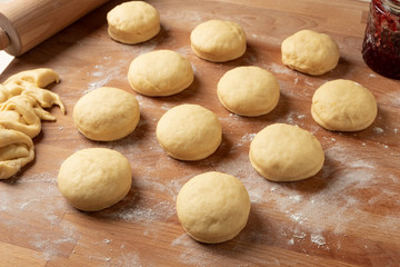 Raw filled  doughnuts rising before being fried