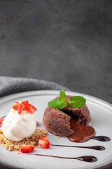 White plate with chocolate fondant cake with ice cream