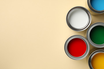 Different paints on beige background, space for text