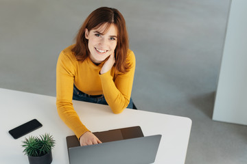 Young woman with a beaming smile in an office