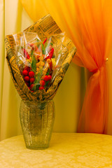 The bouquet consists of food. Sausages, cheese and vegetables are made in the form of a bouquet.
