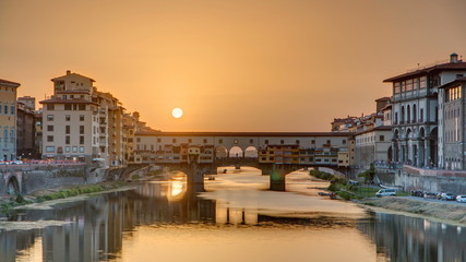 Sunset view of Florence Ponte Vecchio over Arno River in Florence timelapse, Italy.