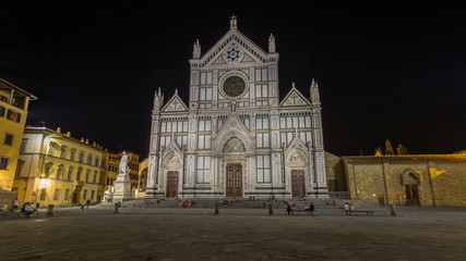 Fototapeta premium Tourists on Piazza di Santa Croce at night timelapse with Basilica di Santa Croce Basilica of the Holy Cross in Florence city.