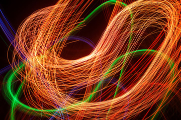 Abstract light pattern. Blurred neon lights. A dynamic backdrop for your design. Bright orange and green