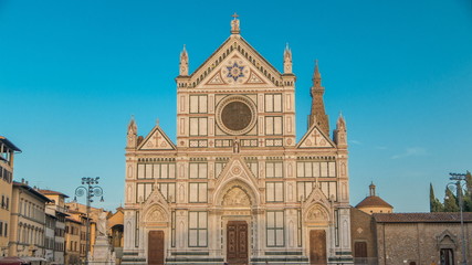 Fototapeta na wymiar Tourists on Piazza di Santa Croce timelapse with Basilica di Santa Croce Basilica of the Holy Cross in Florence city.