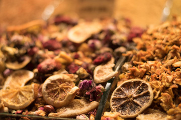 Dried orange slices and other spices in glass shelfs