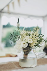 bouquet of flowers in vase on table at wedding