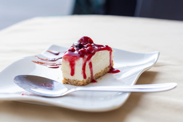 Close-up of pastry with berry on a plate.