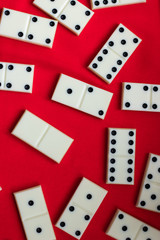 Dominoes Domino bones lie on a red fabric background.