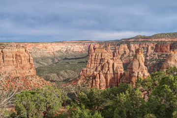 High angle landscape of valley and red and white stone pinnacles and formations at Colorado National Monument in Colorado
