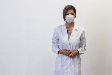 Portrait of serious  young woman with a protective face mask. Coronavirus. Doctor, nurse, pharmacist, beauty therapist, scientist, ophthalmologist, optometrist, beautician, healthcare, isolated on whi
