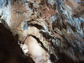 Under the ground. Beautiful view of stalactites and stalagmites in an underground cave-Skelskaya cave, South-West of Crimea. Speleology, the concept of active recreation, extreme travel.