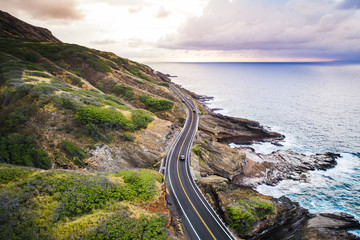 Fototapeta na wymiar Road next to ocean in Hawaii at sunrise