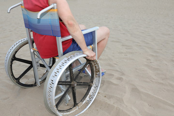 young disabled man in the special wheelchair with aluminum wheel