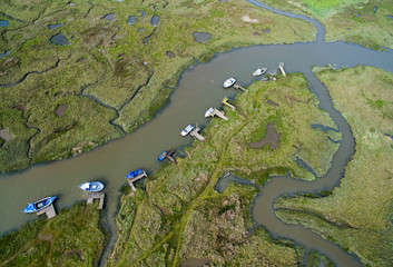 Boats in a tidal harbor, Aerial photo Norfolk. Thornham.  Green, summer sunny.