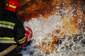 Firefighters extinguish a fire. Fire foam and fire.