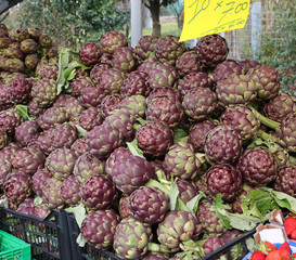 pile of ARTICHOKES for sale at greengrocer s stall at the market