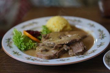 Traditional roast wild boar dish at german game restaurant