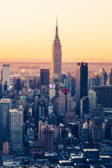 Fototapeta na wymiar Empire State Building NYC Skyline at dawn. Golden warm tones telephoto