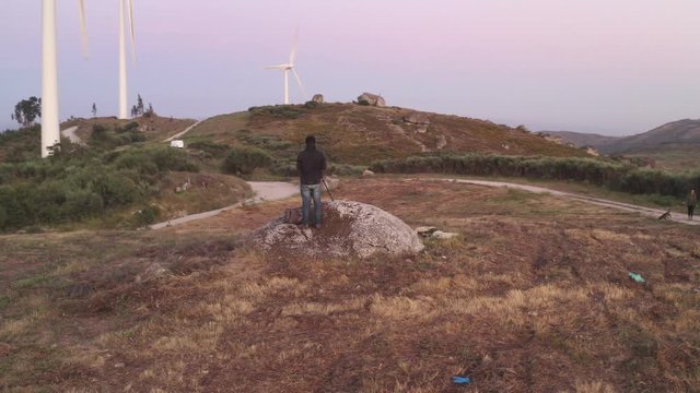Photographer in Casa do Penedo drone aerial view in Fafe with wind turbine, Portugal