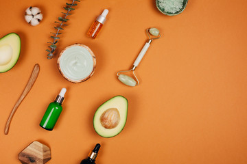 Modern accessories and herbal cosmetics for natural face care. Flat lay style.