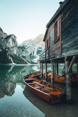 Traditional wooden rowing boat on scenic Lago di Braies in the Dolomites in scenic morning light at...