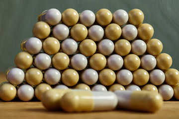 Pills in pyramid shape on dollar bill background