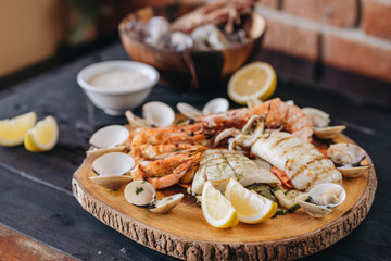 Seafood platter on a black wooden table. Top view