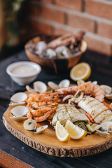 Seafood platter on a black wooden table. Top view