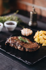 Rare filet mignon beefsteak with roasted potatoes, above view