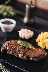 Rare filet mignon beefsteak with roasted potatoes, above view