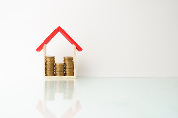 high key. business and finance management conceptual images. stacked money and home replica ...