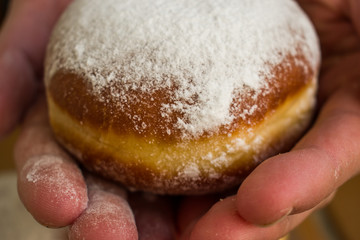 Close up of woman, female hands holding homemade donuts