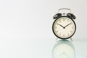 alarm clock isolated on white background with reflection. copy space. high key