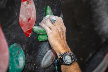 hand climbing on a rock wall