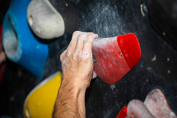hand climbing on a rock wall