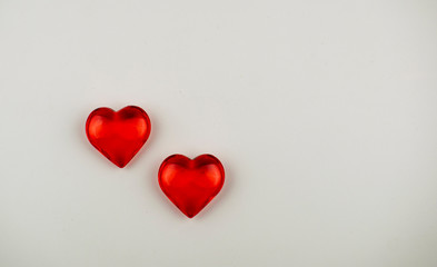 Love inscription made of crystal hearts on a white background.
