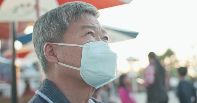 Asian elder man wears mask